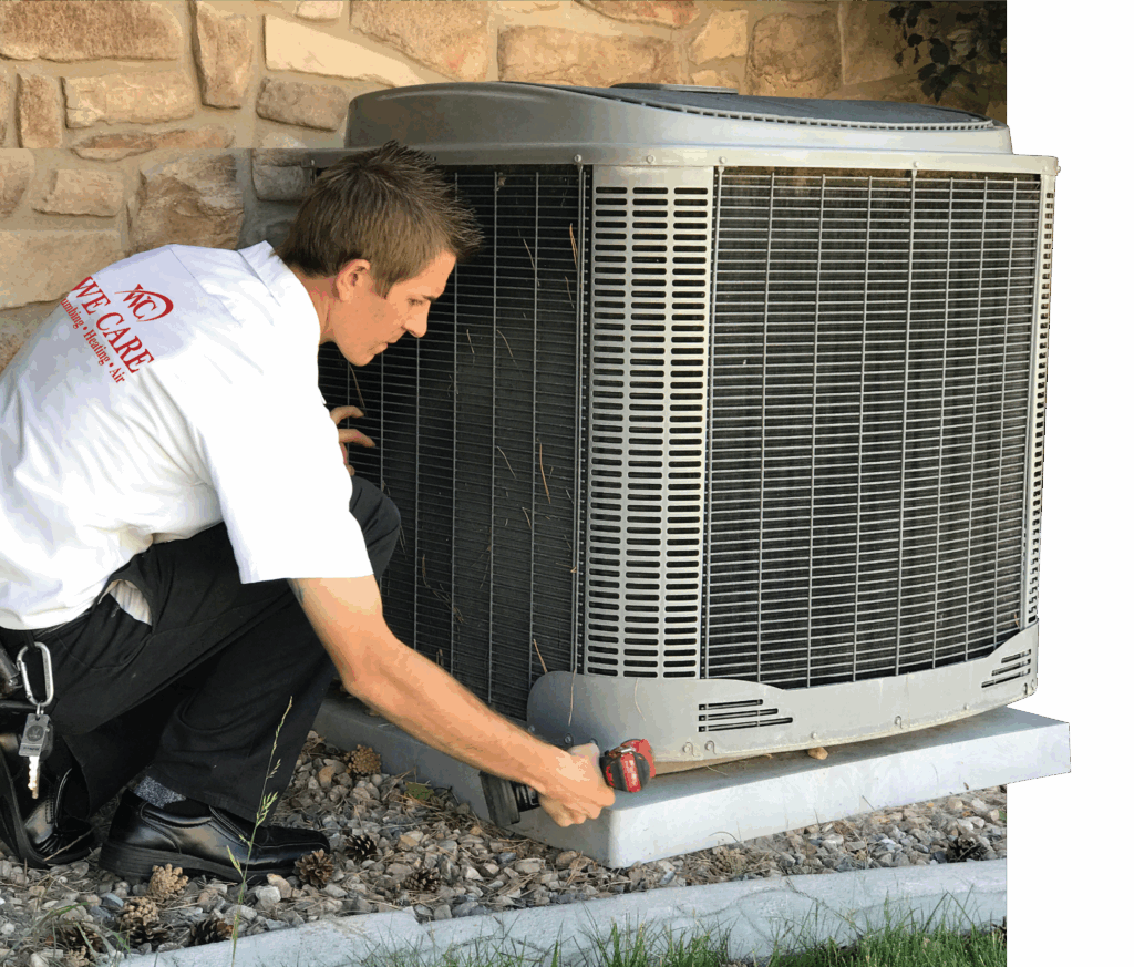 A technician in a white shirt with a We Care logo is installing an outdoor AC unit.