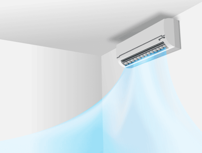 Wall-mounted air conditioner blowing cool air into a corner of a room.