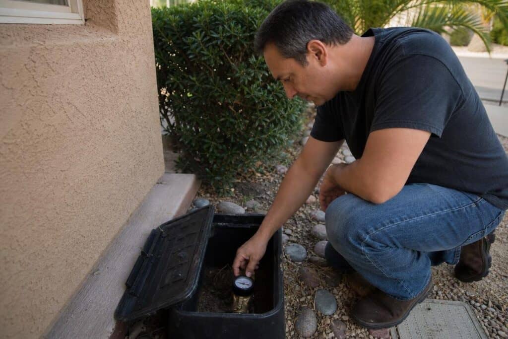 Checking for signs of a hidden water leak beneath a concrete slab